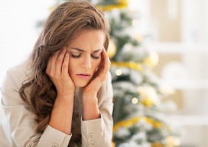 Portrait Of Stressed Young Woman Near Christmas Tree